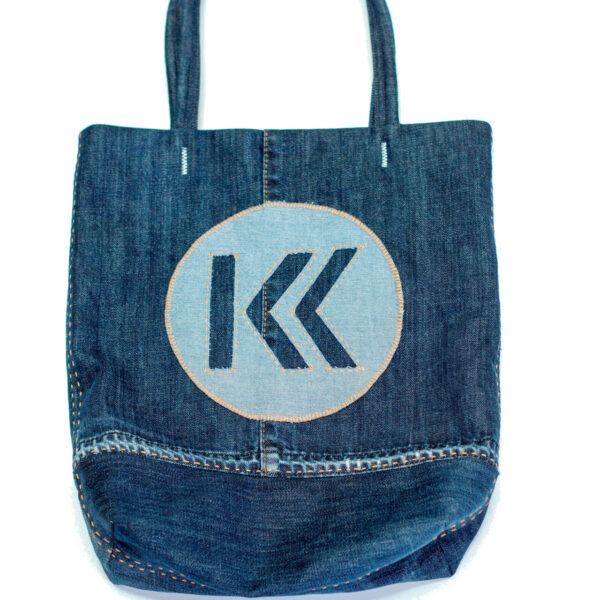 Denim tote bag with big Yukkuri Studio logo and orange stitching.