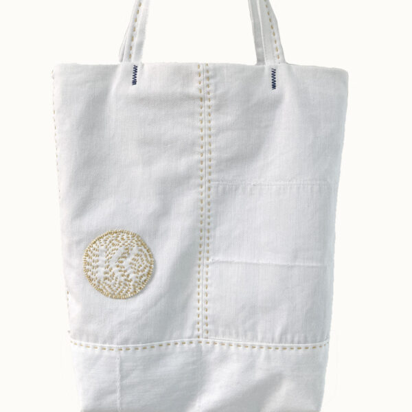 White denim tote bag with yellow sashiko stitches.